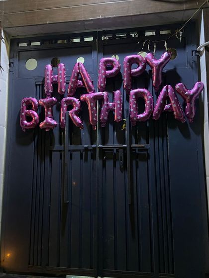 A simple 'Happy Birthday' foil balloon banner on the front door is a great way to welcome the birthday person and guests.