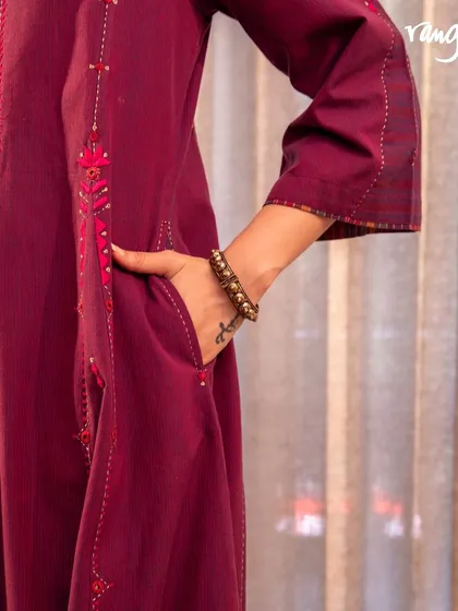 A detail shot of our Haveli Soof-embroidered dress, showing the practical side pocket. This piece blends traditional patterns with a modern touch, perfect for any festive gathering.