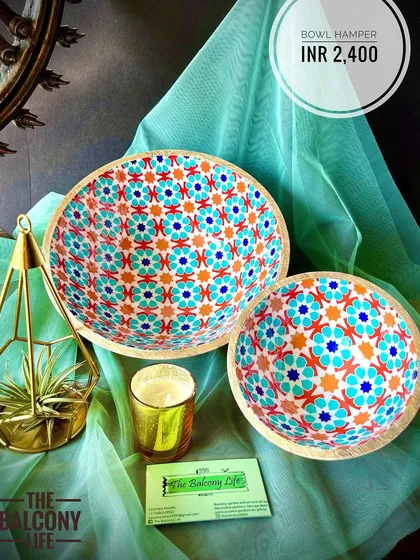 I just love the vibrant pattern on these mango wood bowls. Our Bowl Hamper includes a set of two matching bowls, perfect for serving nuts and snacks during Diwali gatherings. The hamper is completed with an air plant in a brass holder and a lovely scented candle.