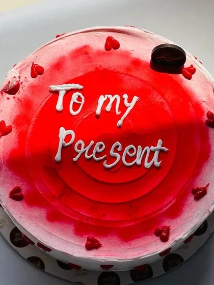 A simple yet heartfelt red velvet cake with a personal message, "To my Present". Sometimes the sweetest messages are the most direct.