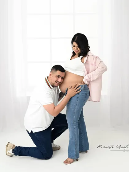 Sometimes the most beautiful moments are the simplest. This casual, light-filled portrait captures a quiet, intimate moment between the parents-to-be, focusing purely on their connection and anticipation.