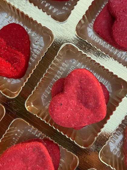 A close-up of our heart-shaped berry chicken biscuits, neatly arranged in their gift box. They are as delicious as they are beautiful.