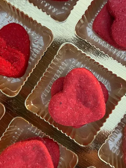 A close-up of my heart-shaped Valentine's biscuits, ready to be packed. They are made with love and healthy ingredients.