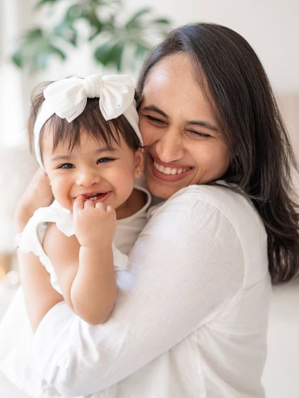 A mother and daughter sharing a big, happy hug.