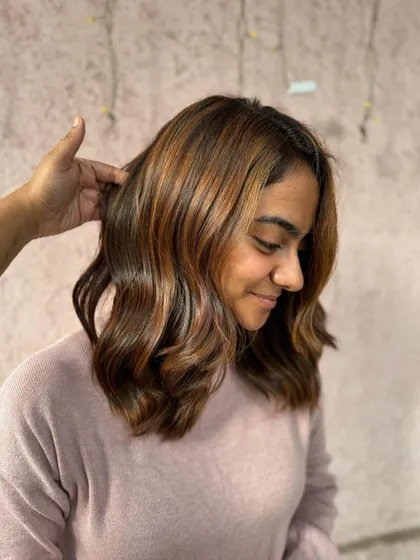 A side view of this beautiful bridal hair. The caramel and brown tones are perfectly blended for a natural, sun-kissed effect.
