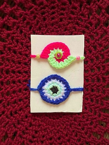 A simple and elegant Evil Eye Rakhi and a snail-themed Rakhi.