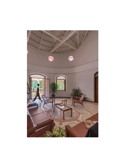 The main hall, post-restoration, is a testament to adaptive reuse. The space is configured for modern living with contemporary furniture, all under the original high ceilings and within the building's historic footprint.