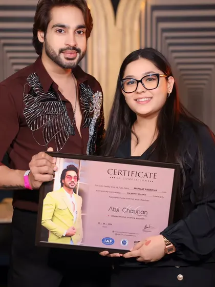 A proud graduate holding her certificate. Her eye for detail is outstanding.