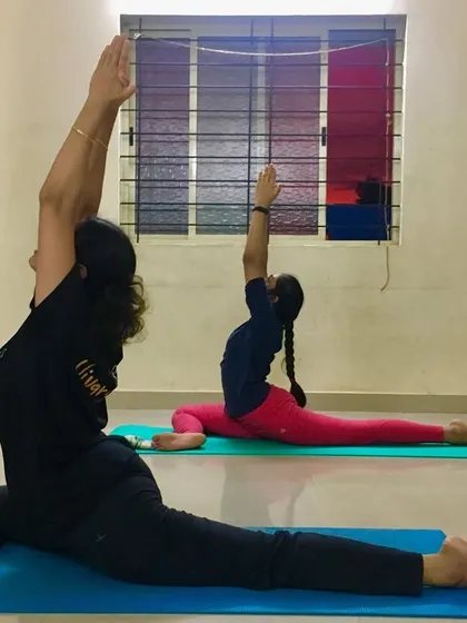 A side view of students in Ekapadasana, highlighting the deep stretch in the hips and back.