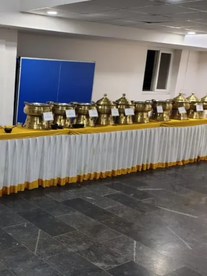 A standard buffet line setup with our signature brass dishes on a clean white and gold table skirt, ready for service.
