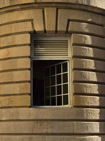 A simple, open window in a stone facade. I'm fascinated by these small details, the way light falls through the panes, and the stories of the lives lived inside.