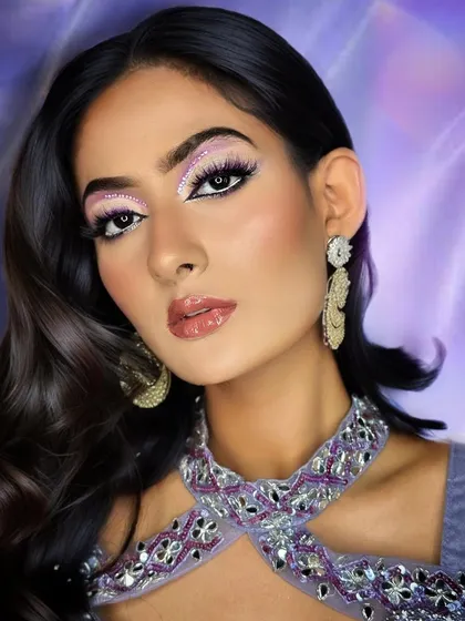 Dewy radiance and captivating eyes. This look combines a flawless, glowing base with a dramatic, shimmering eye, a perfect blend for any glamorous event.
