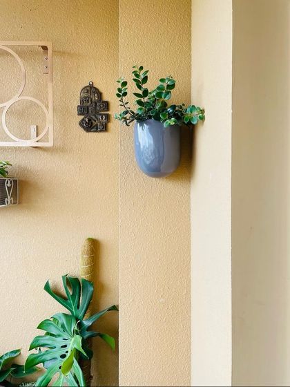 A wider view showing how a single wall planter can complement other design elements. The goal is to create a balanced and organized look, even in a small corner of a balcony.
