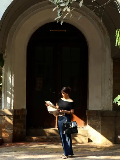 A candid-style shot of the model reading a map, creating a narrative for the campaign and making it more than just a fashion photo.