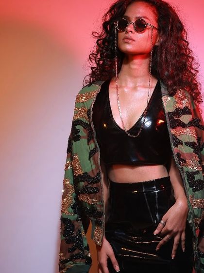 This shot for Diseno.in captures a cool, urban vibe. The combination of a vinyl top and sequined jacket is lit to showcase different textures, a key element in quality fashion photography.