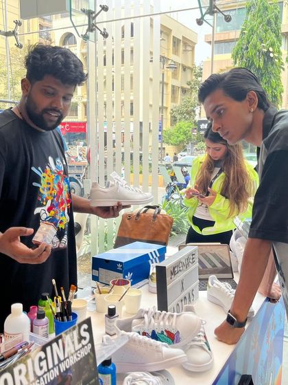 An artist discussing paint options and design possibilities with a customer. The process is transparent and collaborative from start to finish.