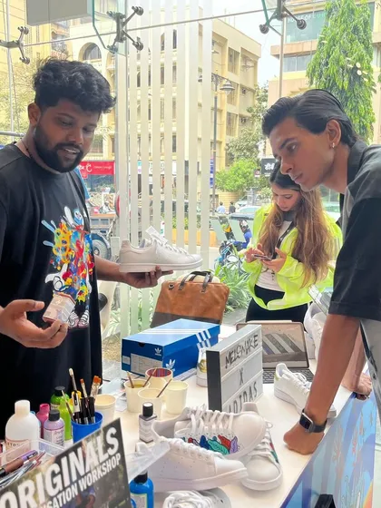 An artist discussing paint options and design possibilities with a customer. The process is transparent and collaborative from start to finish.