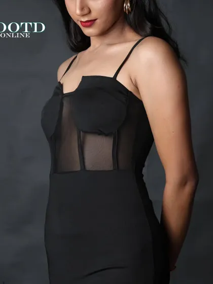A close-up shot focusing on the mesh corset detail of the dress. This highlights the unique design features that make the product stand out.
