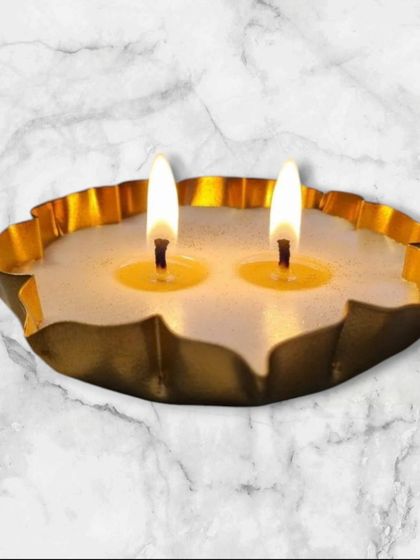 A simple yet elegant two-wick candle poured into one of my golden lotus urlis. The wide surface is perfect for a strong fragrance throw.