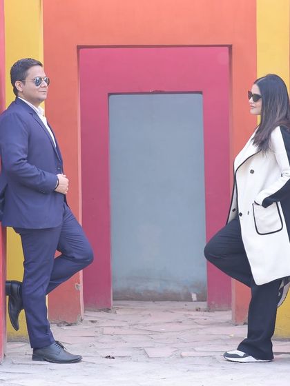 A stylish pre-wedding photo of a couple posing against our vibrant, multi-colored wall set, perfect for a modern and chic photoshoot.