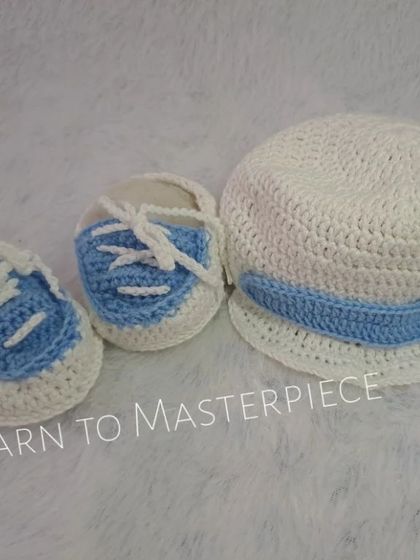 For a baby boy's baptism, I created this handsome set featuring a newsboy-style cap and matching sneaker-style booties in white and blue.