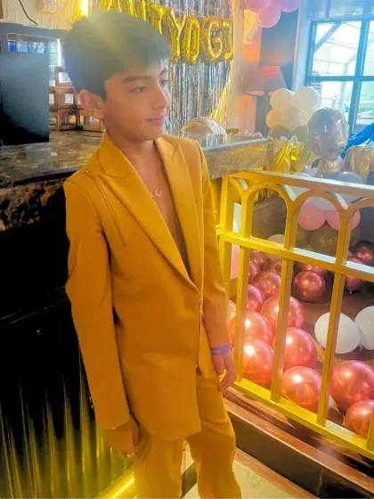 Another shot of the custom mustard suit, showing how even a bold color can be crafted into a sharp, elegant silhouette for a special event.