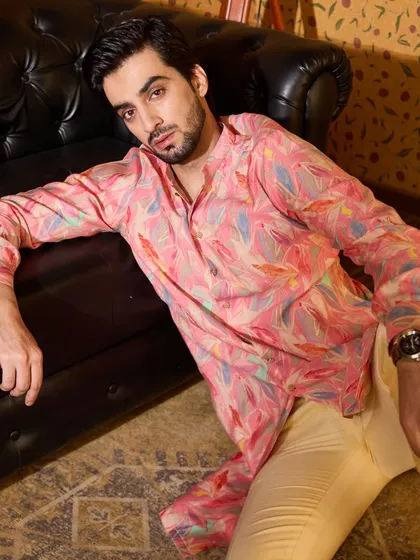 The popping pink kurta paired with simple cream trousers makes for a comfortable yet eye-catching outfit.
