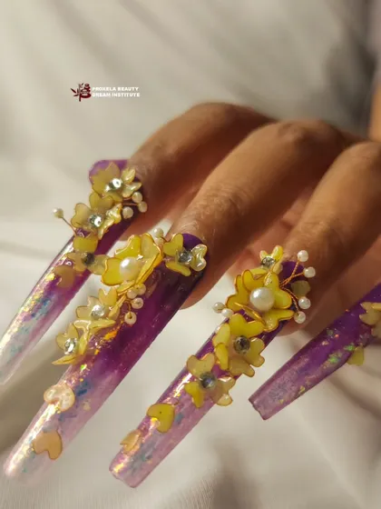 The finished look of the purple and yellow 3D floral nails. The combination of the iridescent base and the detailed flower sculptures creates a truly enchanting set.