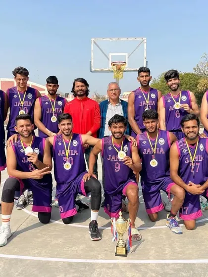 Celebrating a hard-fought victory. Our university basketball team proudly displays their medals and trophy after securing second place in an All India University tournament.