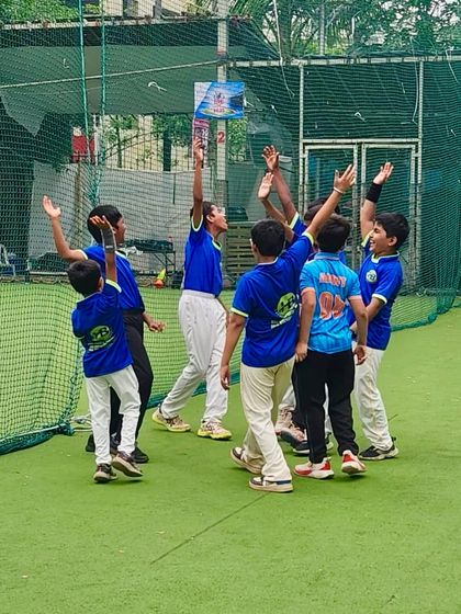 Young football players celebrate a goal during the HB Jr. Cup. Our training environment encourages teamwork and celebrating small victories together.