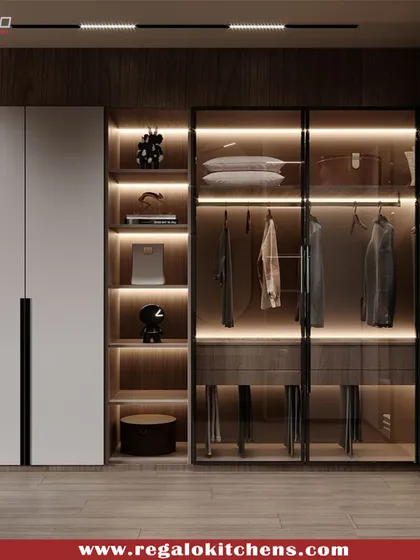 This L-shaped wardrobe combines solid white doors with open, glass-fronted corner shelving. The integrated lighting turns the corner into a beautiful display feature.
