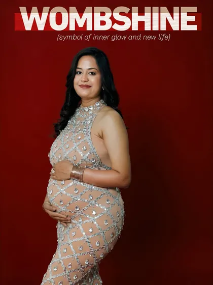 I call this feeling 'Wombshine', the inner glow of creating new life. This portrait is all about celebrating the mother's strength and confidence, using a bold red background and a sparkling gown to create a powerful, glamorous statement.