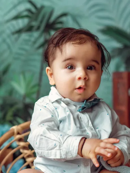 A close-up on this handsome little man. The jungle-themed background adds a touch of adventure to his milestone session.
