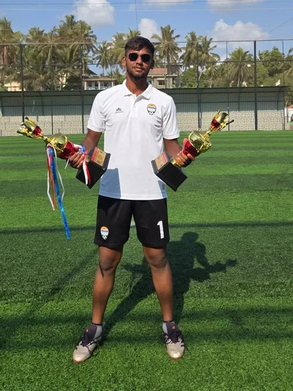Coach Jisto Francis with two of the championship trophies won by our teams in Goa.