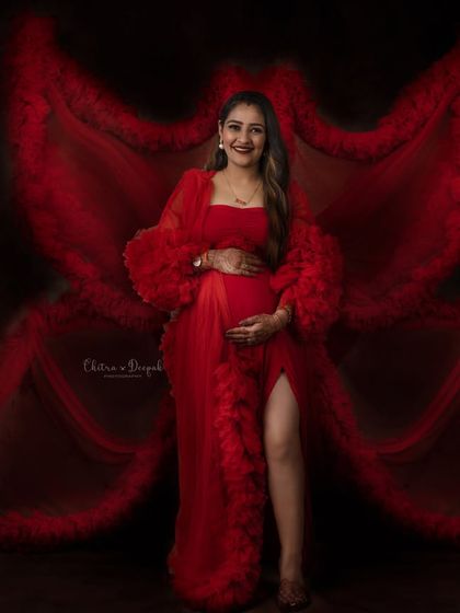 Creating a butterfly effect with this stunning red gown. This is a perfect example of how we use fabric to create artistic and imaginative portraits.