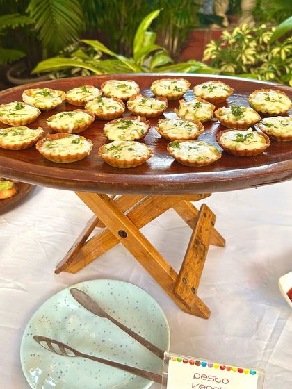 A platter of delicious pesto veggie tarts, ready to be served. These bite-sized treats are packed with flavour and look beautiful on any buffet table.