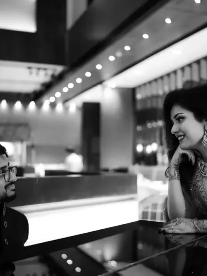 A quiet moment of conversation. Monochrome helps focus on the couple's interaction and the subtle emotions shared between them.