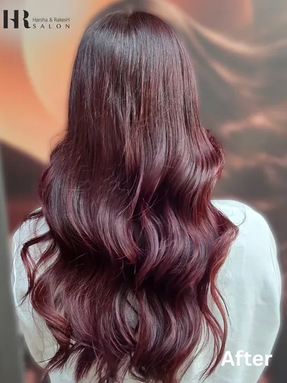 The final result of a rich burgundy color with subtle highlights. The deep red tones are enhanced with lighter pieces, creating a look that is both elegant and bold, styled into soft waves.