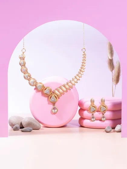 Trends fade, but a statement lasts forever. This matte gold necklace and earring set, with its unique geometric forms, is for the woman who understands that true luxury is about timeless style.