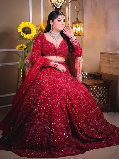 A seated portrait that allows the magnificent trail of the lehenga to be displayed.