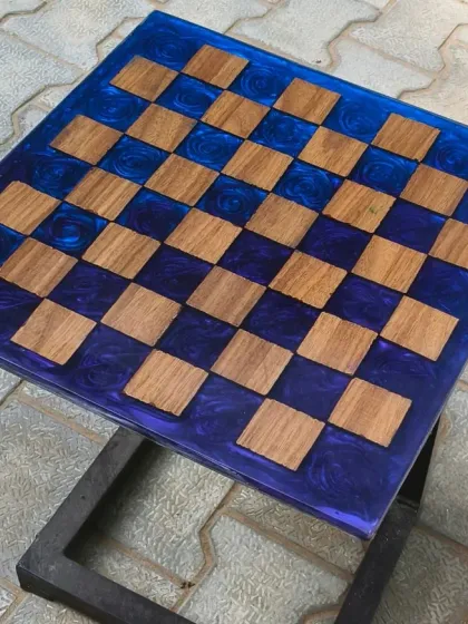 A functional piece for game lovers. This custom chess board table was made by setting wooden squares into a deep blue, swirling resin base.