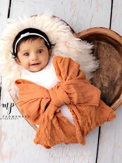 A happy, smiling baby in the heart bowl. These awake shots are full of personality.