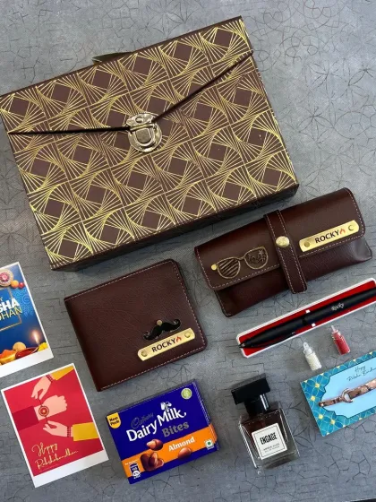 This stylish Rakhi hamper comes in a premium patterned box. Inside, you'll find a personalized wallet and eyewear case, perfume, chocolates, and Rakhi cards.
