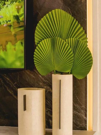 An artistic arrangement using dried Fan Palm leaves. In addition to live plants, we can create unique botanical sculptures and arrangements for a modern, maintenance-free option.