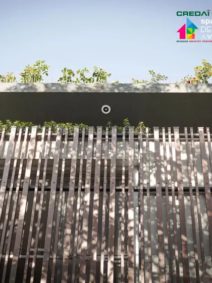 The rooftop greenery is visible above the facade screen, a signature element in our designs that helps to cool the building and give something back to nature.