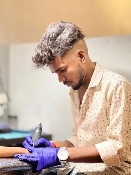 Artist Parseya in the zone, working on a new piece. Our team is passionate about bringing your vision to life.
