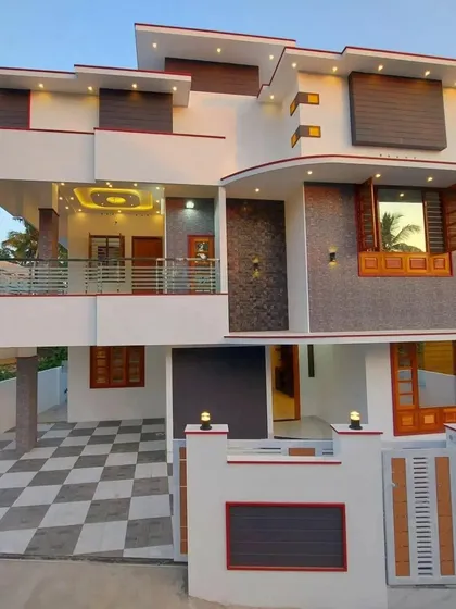 A spacious residential design featuring multiple balconies and a distinctive curved element on the facade. The combination of white walls, grey stone cladding, and wood-paneled window shutters gives the home a unique and inviting character.