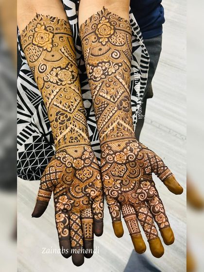 A gorgeous engagement bridal set for Ameena. The design covers both hands and extends up the forearms with symmetrical patterns featuring roses and geometric elements.