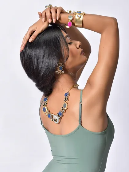 A graceful pose that elongates the neck and beautifully displays the necklace and earrings from the Curiocottage collection.