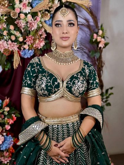 A close-up of the intricately embroidered blouse of our emerald green lehenga. The craftsmanship is what makes our rental pieces feel so luxurious.